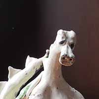 white clay dragon sculpture